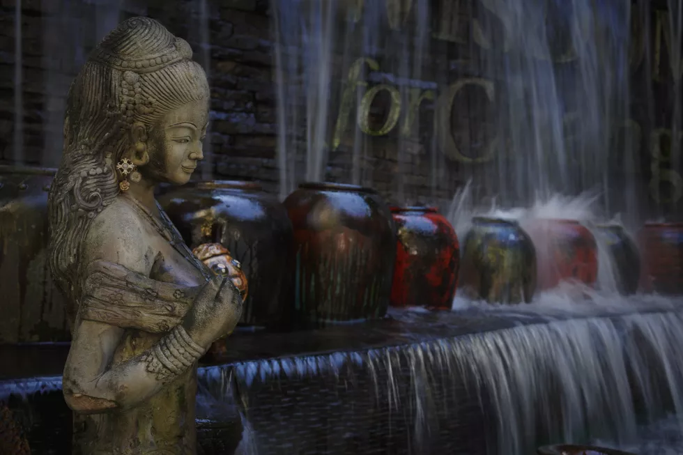 statue-against-blurred-flowing-water