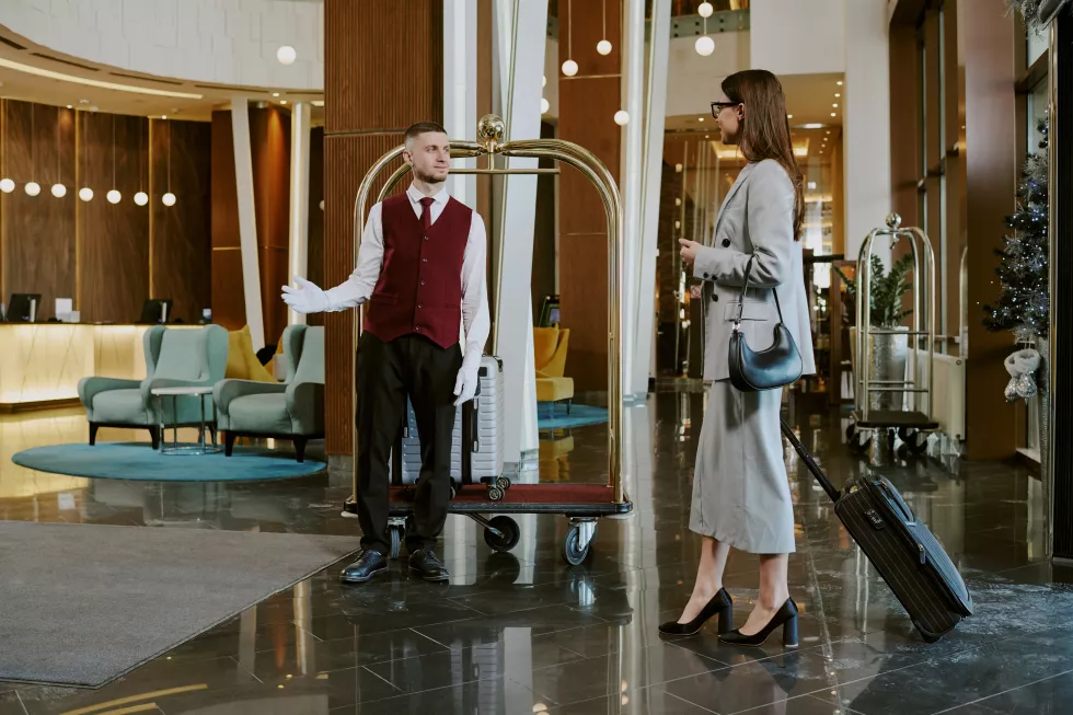 elegant-woman-with-small-suitcase-entering-hotel-lobby
