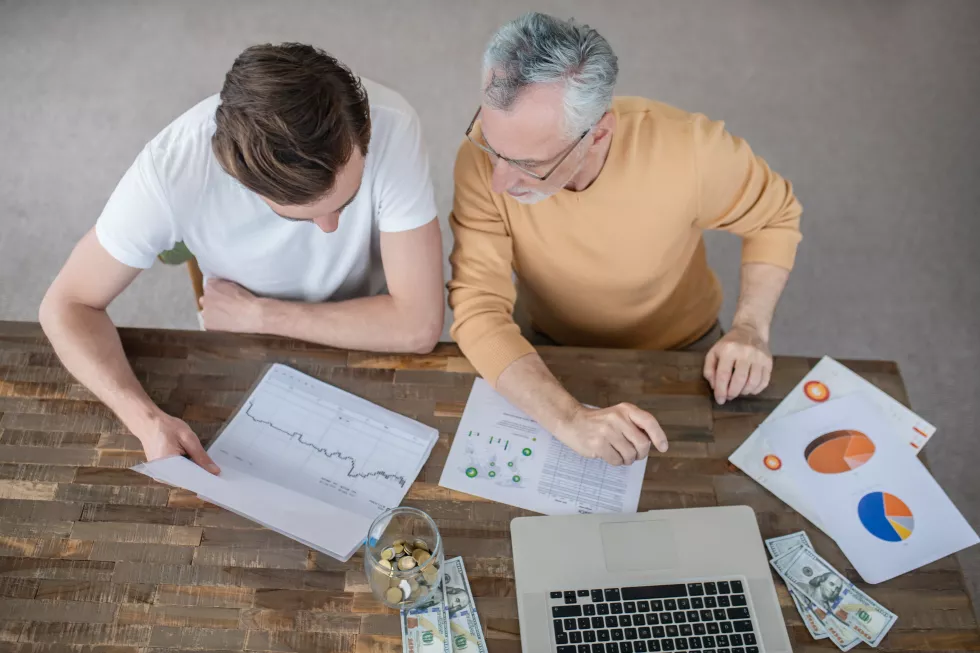 two-men-working-together-project-looking-concentrated