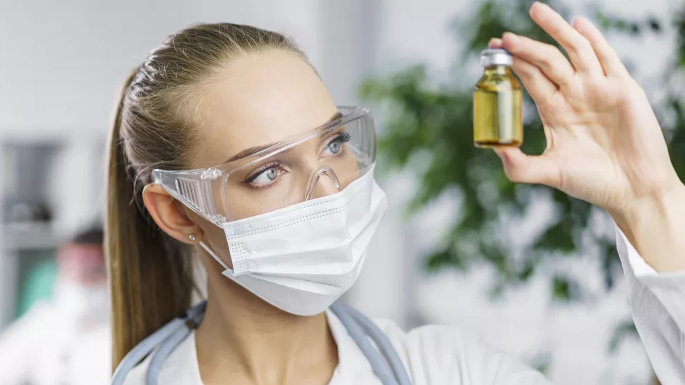 front-view-female-researcher-with-medical-mask-vaccine
