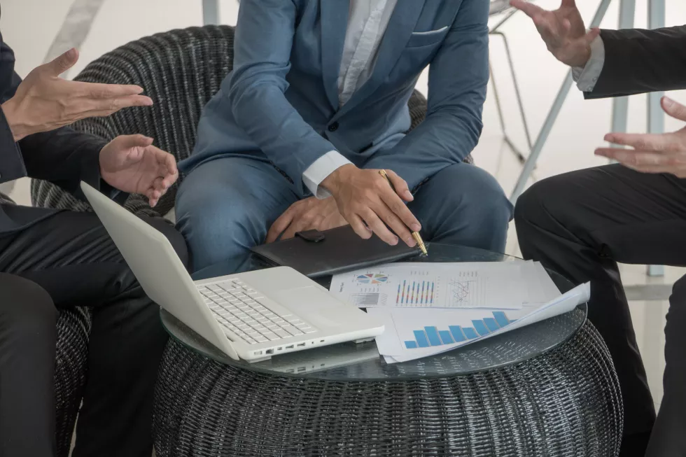 business-colleagues-discussing-laptop-office