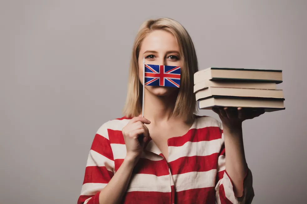 beatiful-girl-holds-british-flag-books