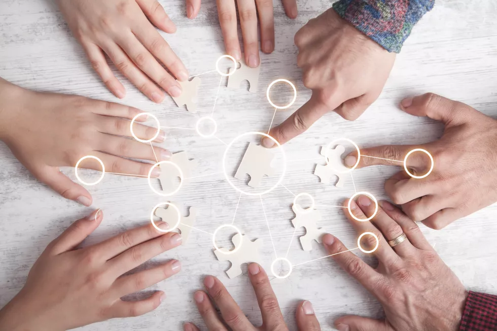 hands-people-holding-jigsaw-puzzle