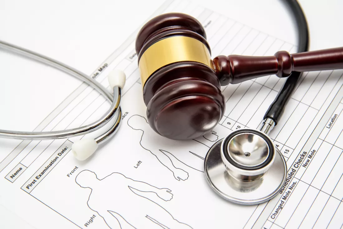 wooden-judge-gavel-stethoscope-medical-chart