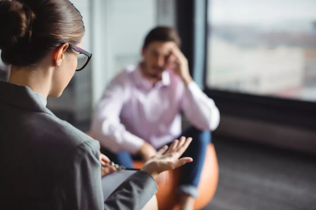 counselor-interacting-with-unhappy-man