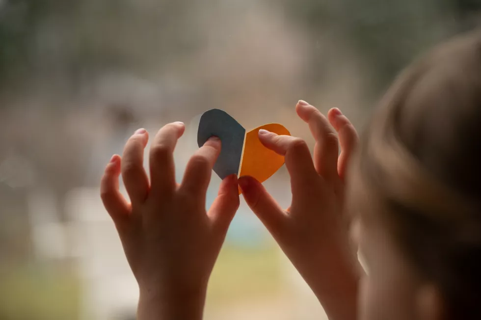 conceptual-image-tragedy-orphans-ukrainian-war-little-child-pressing-yellow-blue-paper-cut-heart-window