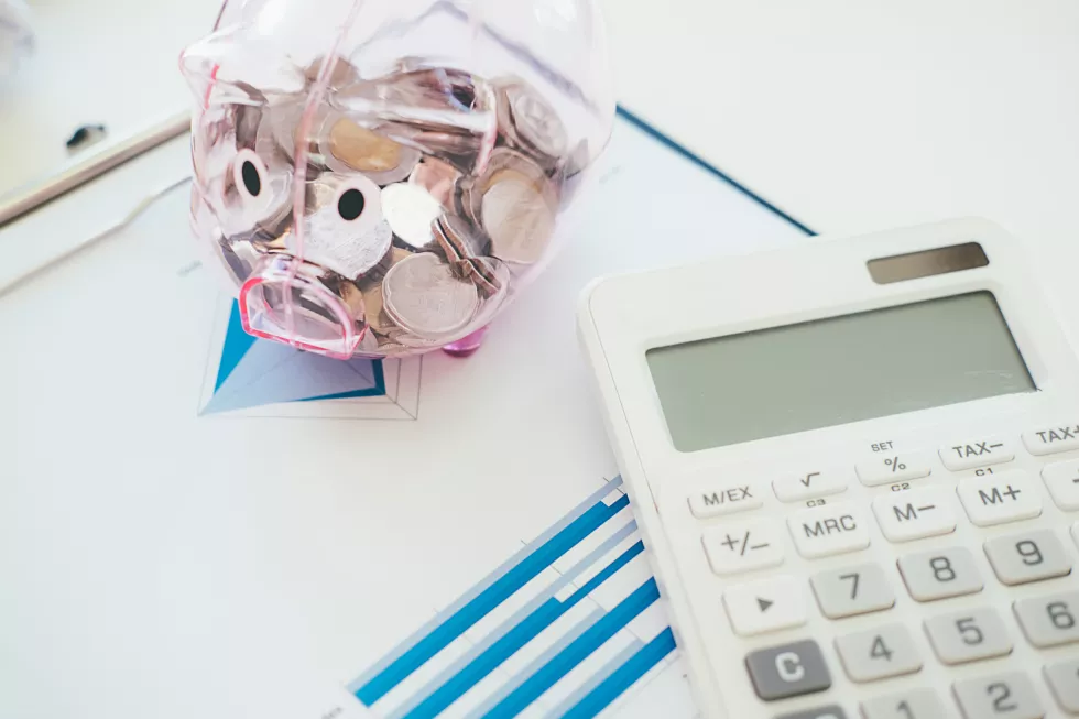 high-angle-view-calculator-with-piggy-bank-table