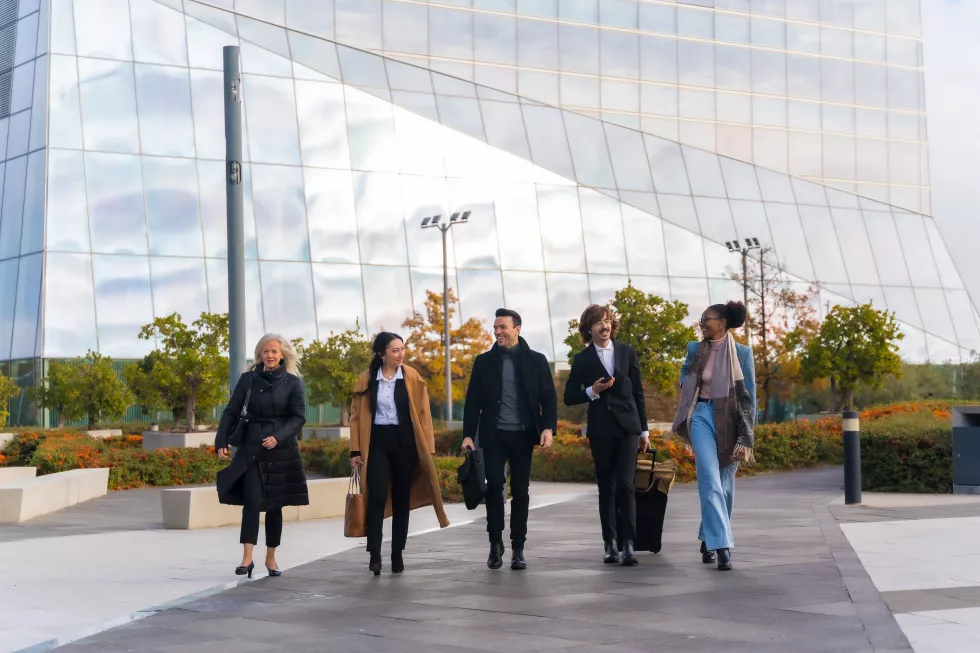 group-multiethnic-business-people-with-suitcases-business-park-walking-work