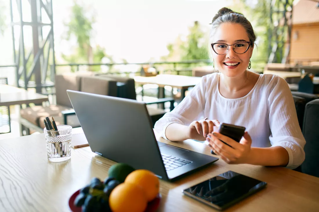 young-mixed-race-woman-working-with-laptop-cafe-looking-camera-asian-caucasian-female-studying-using-internet-business-woman-doing-social-marketing-work-shopping-telecommuting-concept