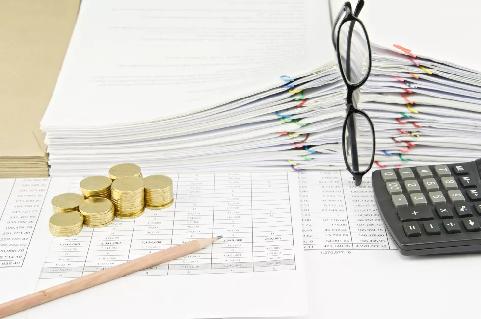 stack-coins-documents-with-eyeglasses-table-office