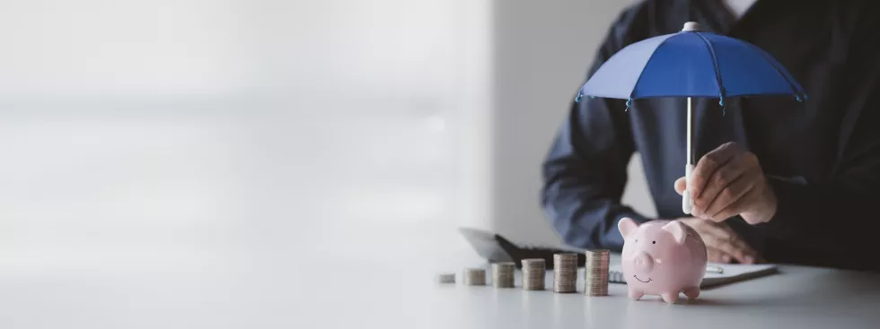 person-spreads-small-umbrella-piggy-bank-large-stack-coins-money-saving-concept-money-management-income-expenses-personal-finance