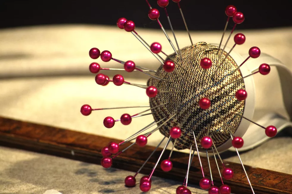 close-up-pink-colored-pins-pin-cushion