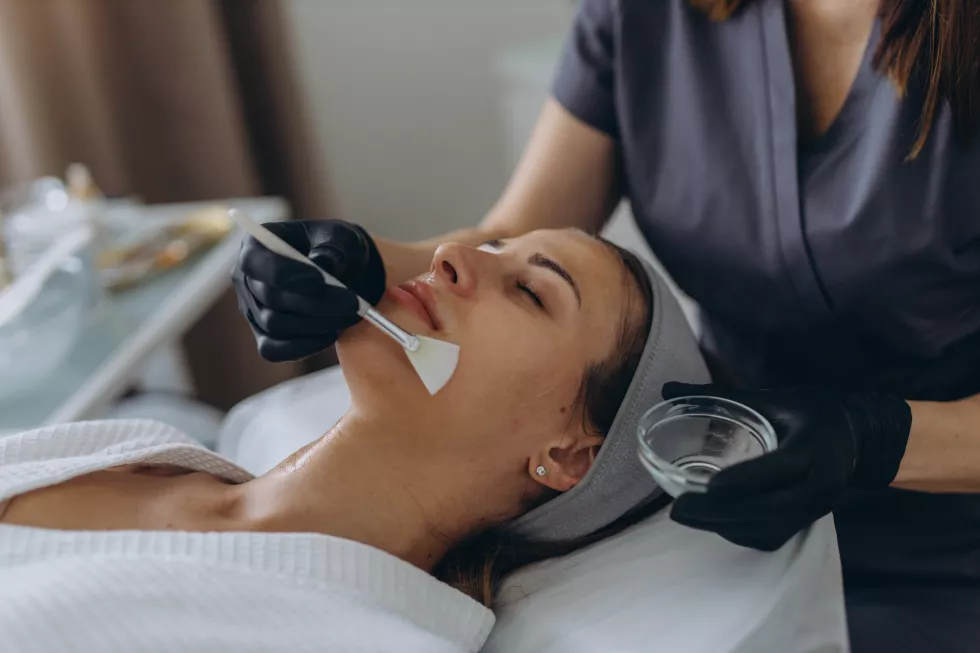 cosmetologist-performs-facial-peeling-procedure-young-woman