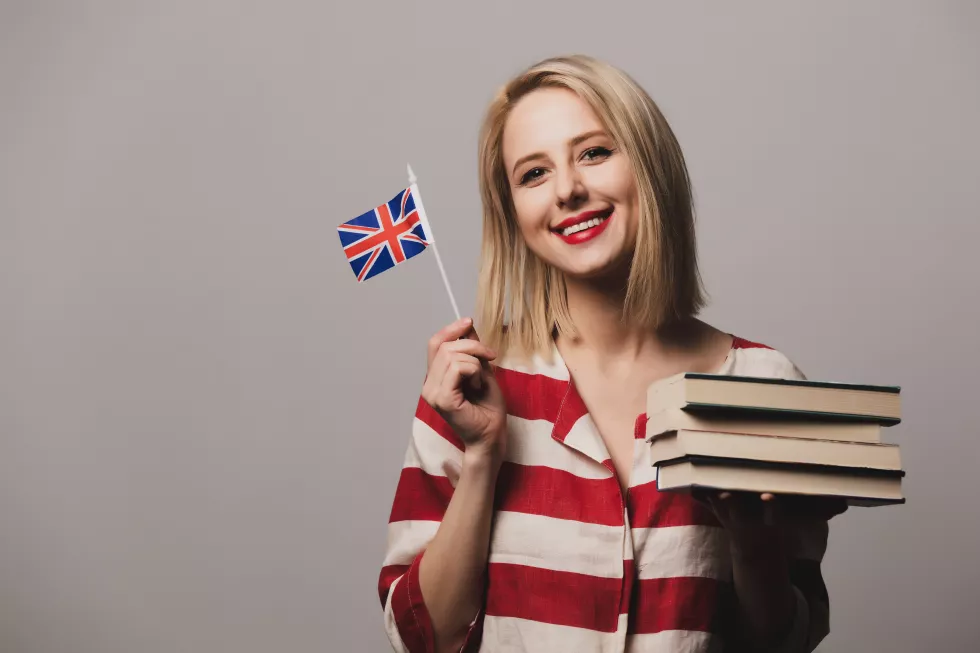 beatiful-girl-holds-british-flag-books