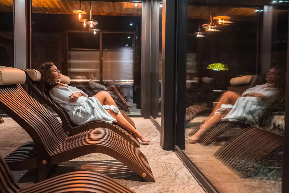 indoor-relaxation-area-with-lounge-chair-glass-window-italian-alps