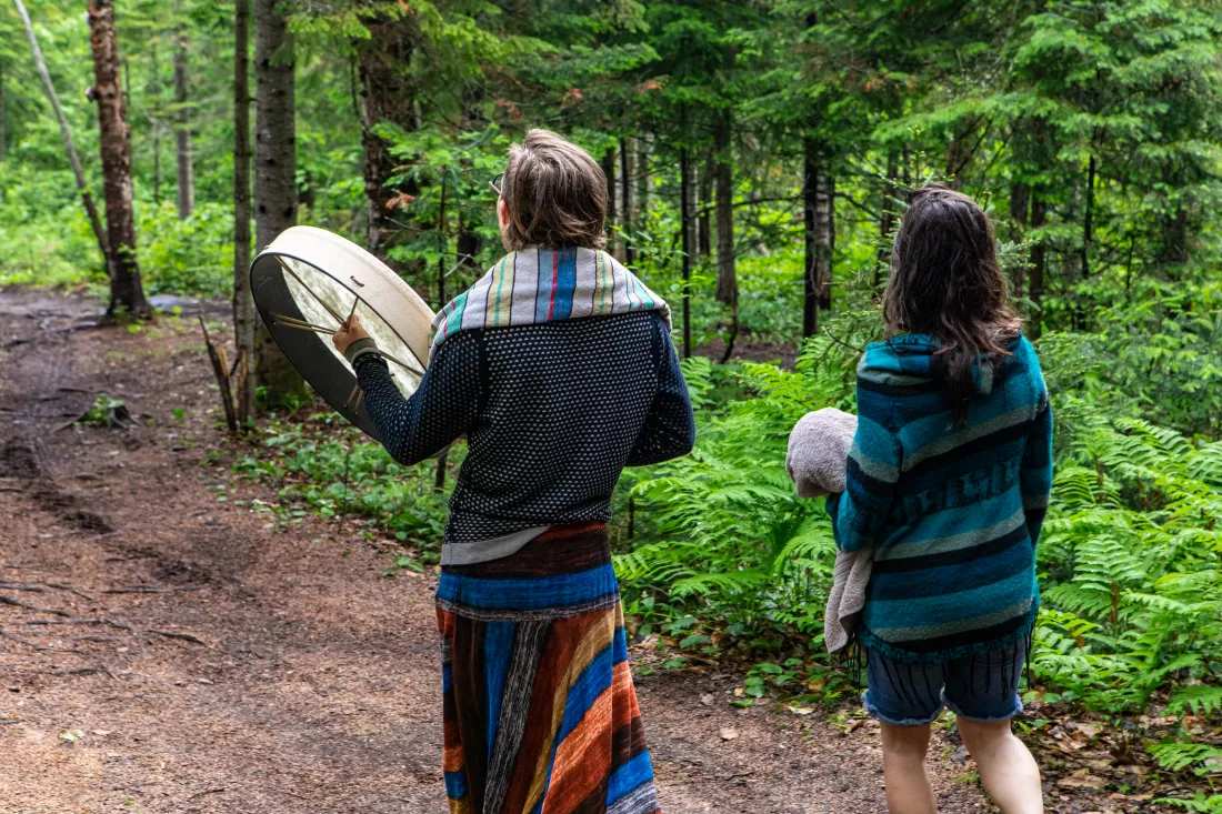 rear-view-people-walking-forest