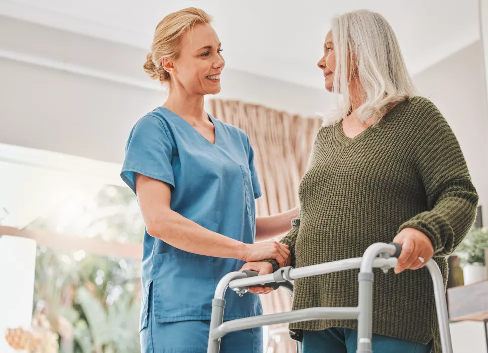 senior-patient-nurse-walker-help-house-physiotherapy-mobility-recovery-nursing-home-assisted-living-professional-woman-with-disability-health-care-trust-support
