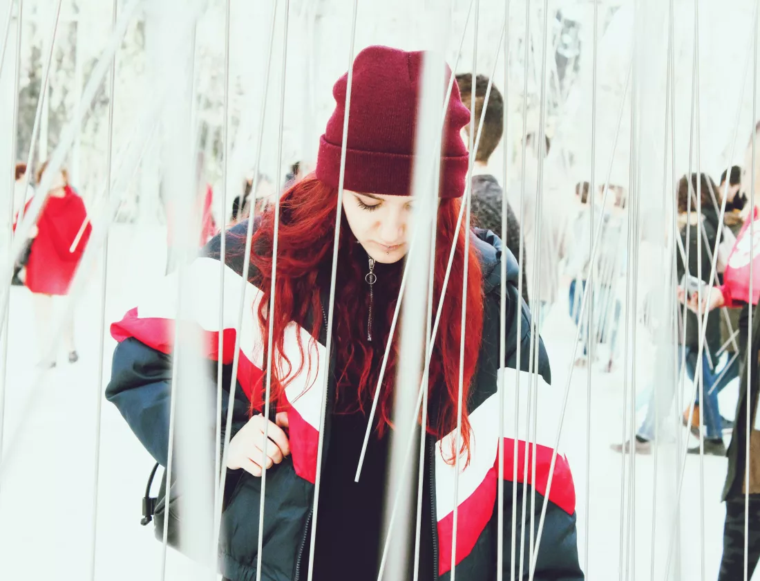 woman-warm-clothing-standing-amidst-strings