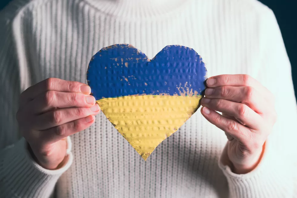 midsection-woman-holding-heart-shape