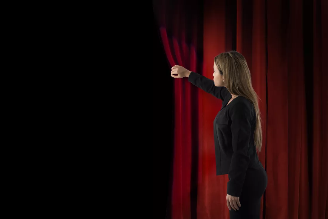 woman-open-red-curtains-theater-stage
