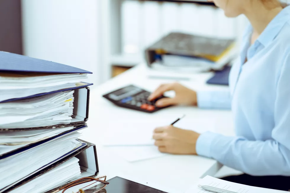 calculator-binders-with-papers-are-waiting-be-processed-by-business-woman-bookkeeper-back-blur-internal-audit-tax-concept-2