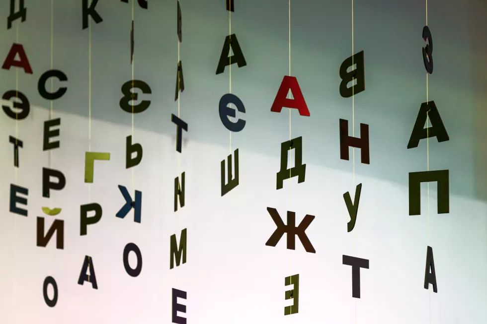 indoor-decorations-from-black-letters-hanging-threads-background-white-wall