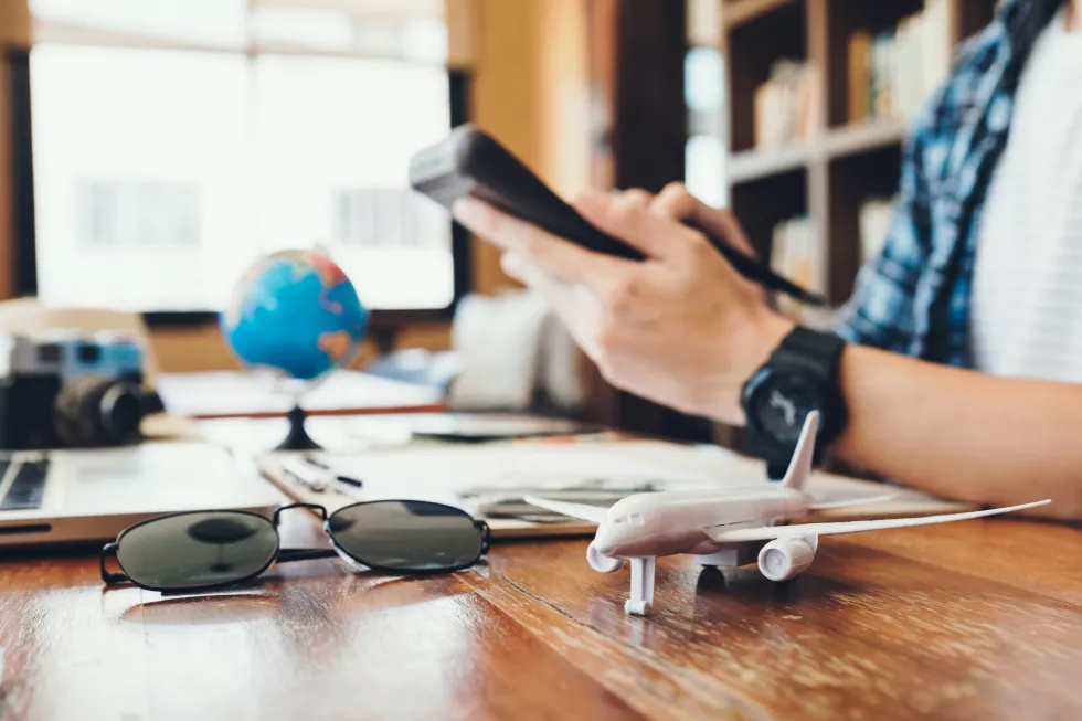 midsection-man-holding-calculator-table