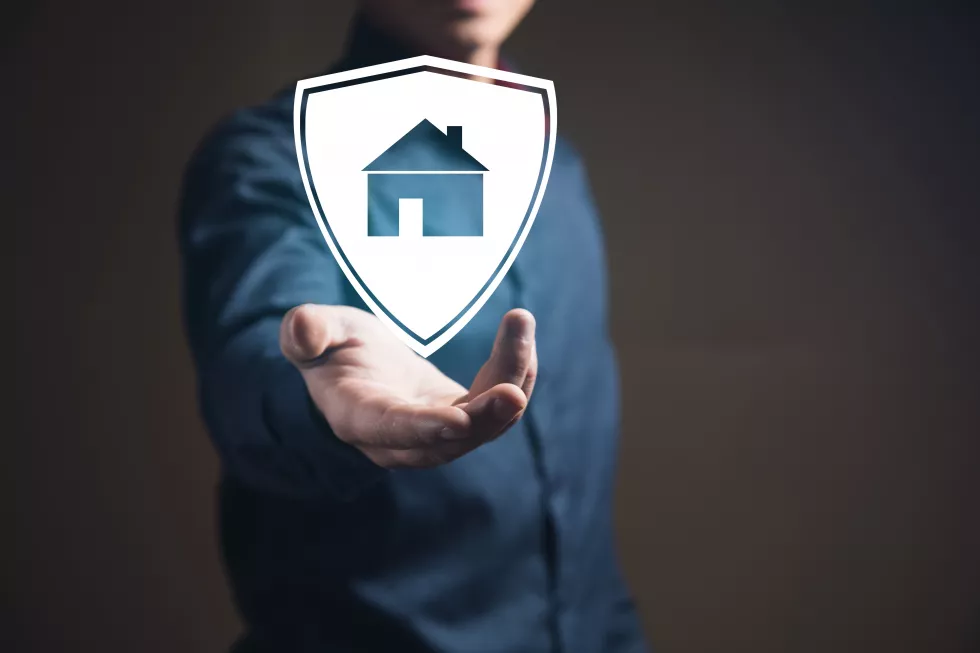 businessman-holding-billboard-with-house-home-safety