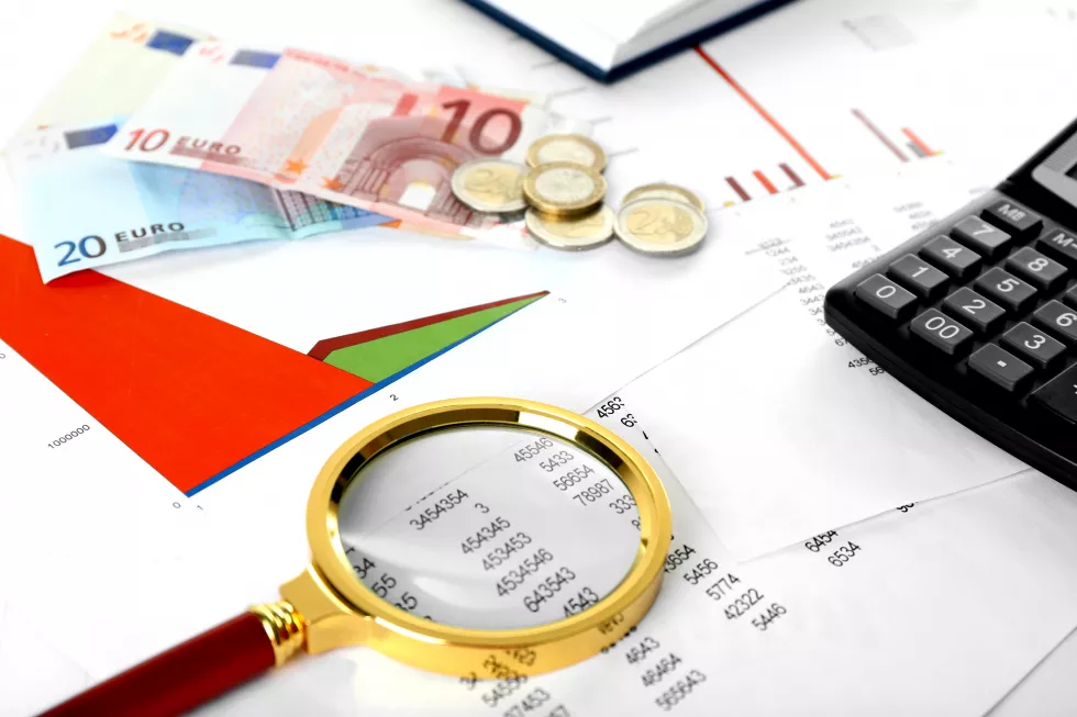 magnifying-glass-financial-documents-background-closeup