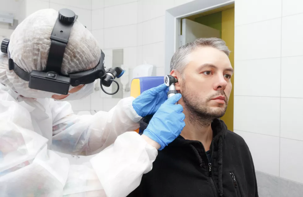 profile-photo-otolaryngologist-holding-otoscope-patient-s-ear-making-examination