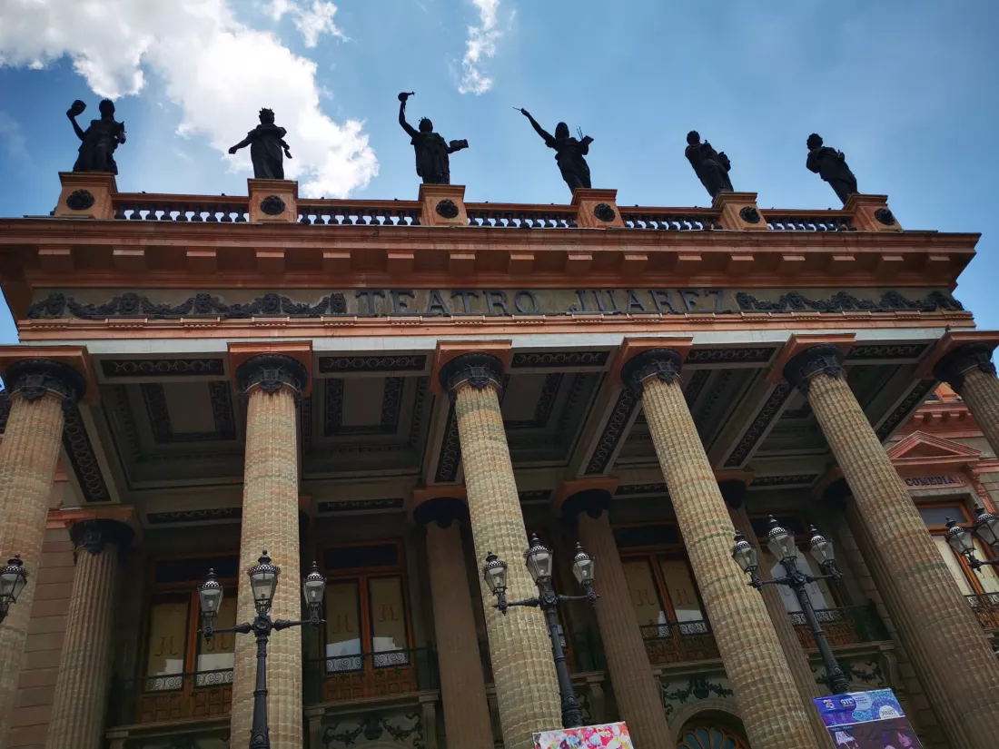 low-angle-view-historical-building-against-cloudy-sky