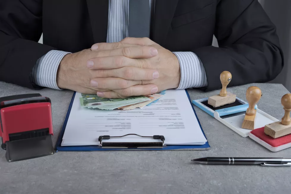 midsection-man-holding-paper-table