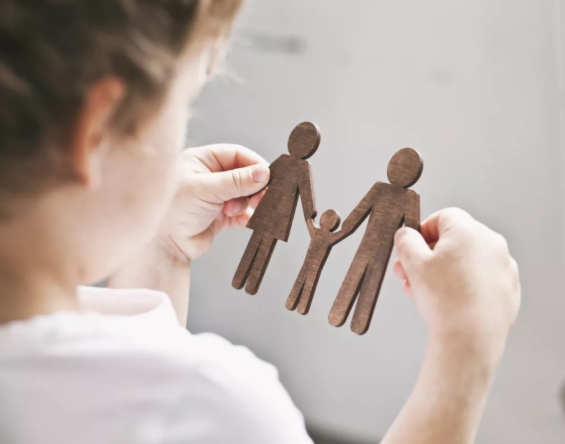little-child-looking-wooden-figures-mom-dad-child-his-hands-concept-child-dreaming-about-family