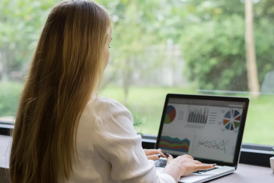 businesswoman-using-laptop-desk-office