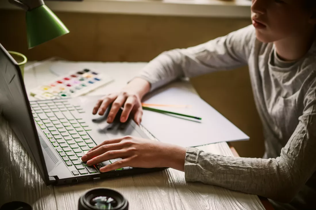 midsection-woman-using-laptop-table