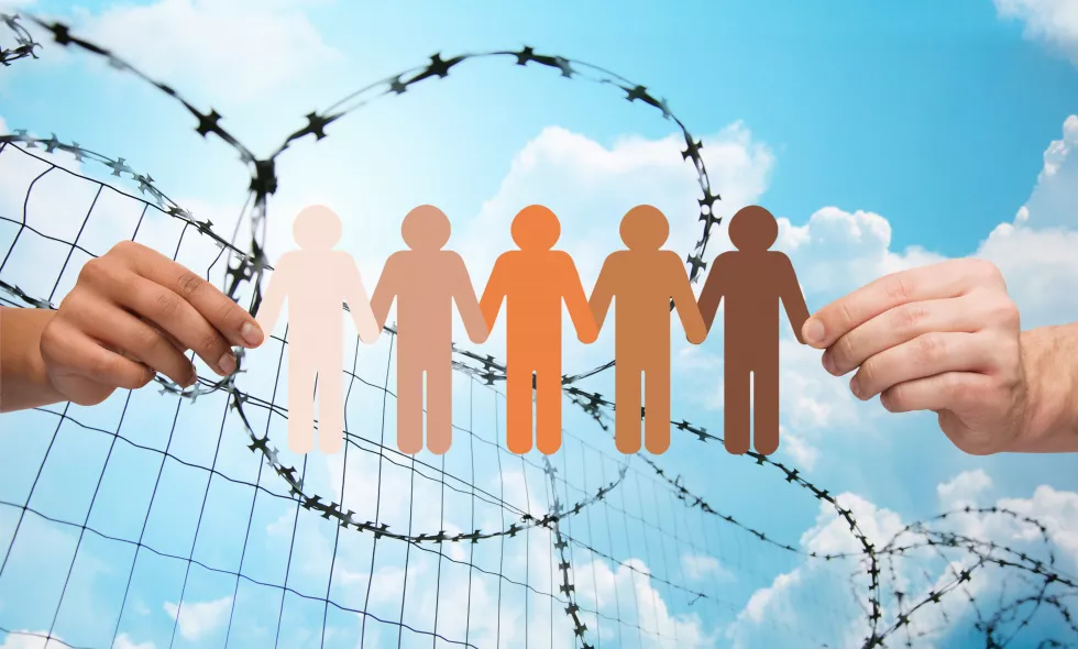 crime-imprisonment-refugee-humanity-concept-multiracial-couple-hands-holding-chain-paper-people-pictogram-blue-sky-barb-wire-background