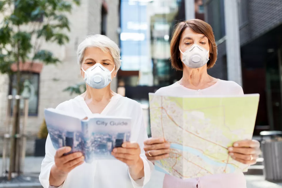 senior-women-with-city-guide-map-face-masks