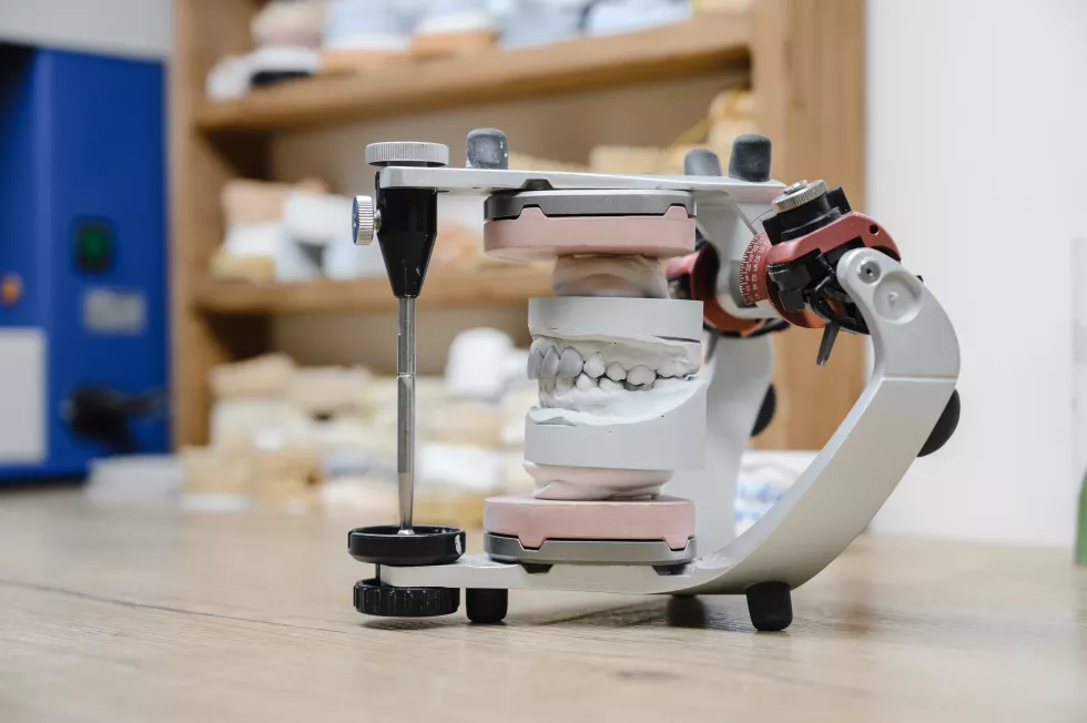 workplace-dental-technician-with-plaster-models-articulator