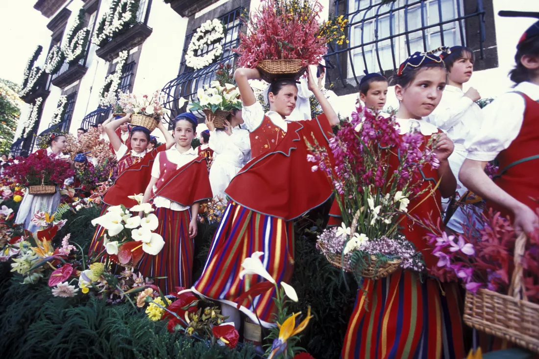 children-traditional-clothing-carrying-flowers