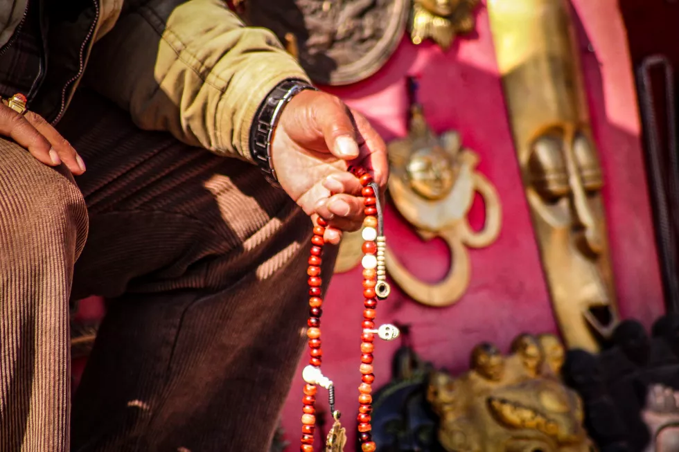 close-up-hand-holding-prayer-beads