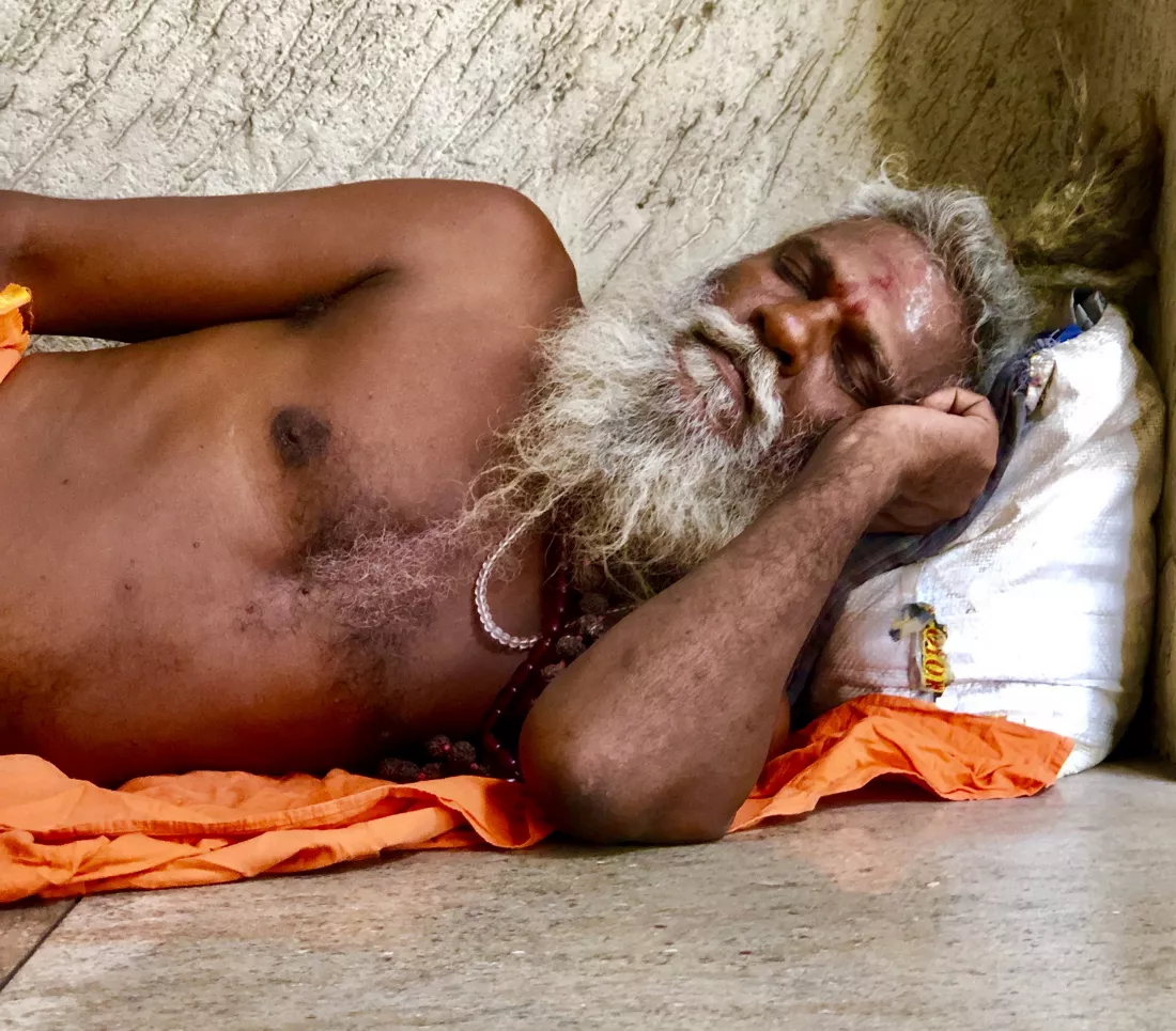 sadhu-sleeping-floor-against-wall