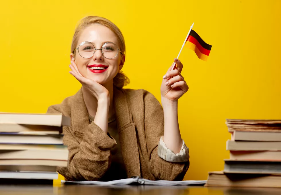 style-blonde-woman-sitting-table-with-books-flag-germany-yellow(2)