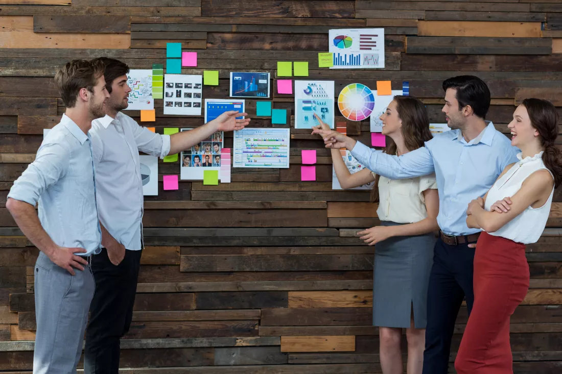 business-executives-discussing-sticky-notes
