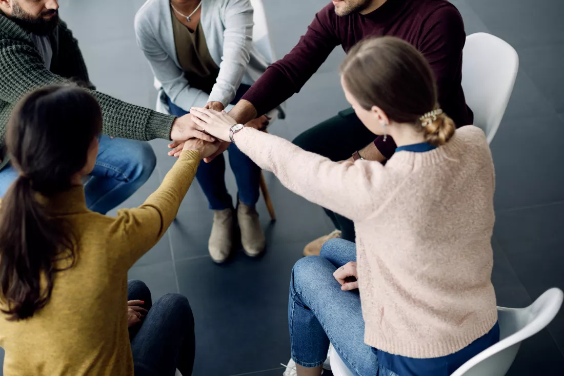 participants-group-therapy-gathering-hands-unity-session-medical-center