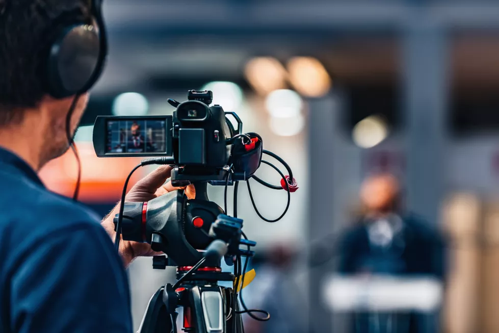 cameraman-recording-event-media-press-conference