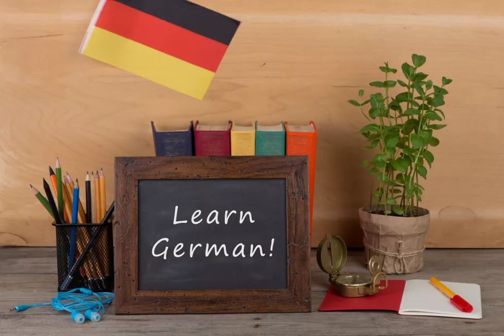learning-languages-concept-blackboard-with-text-learn-german-flag-germany-books-chancellery