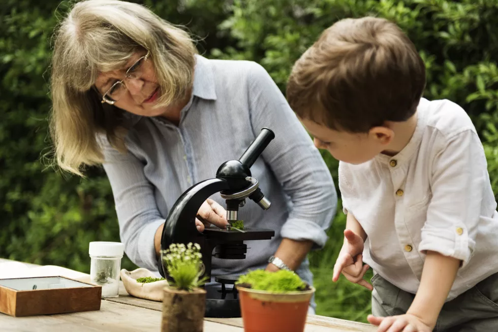 young-boy-learning-with-old-woman-telescope