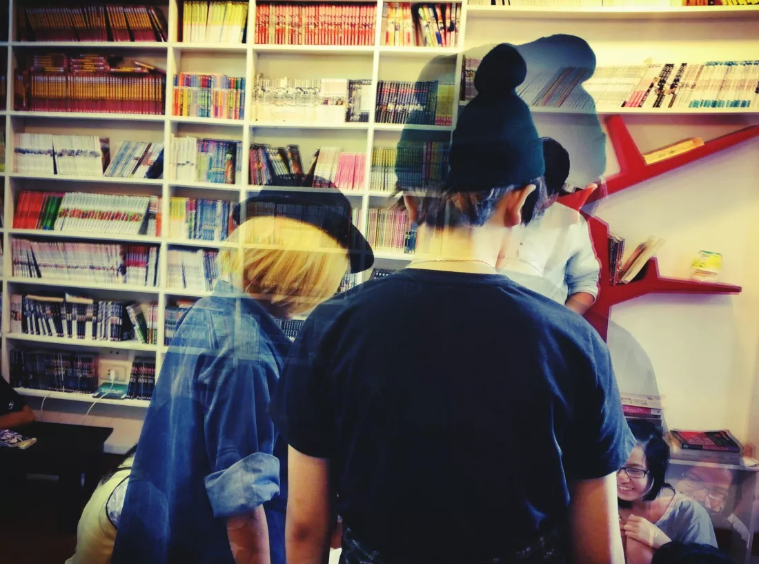people-standing-library-seen-through-window