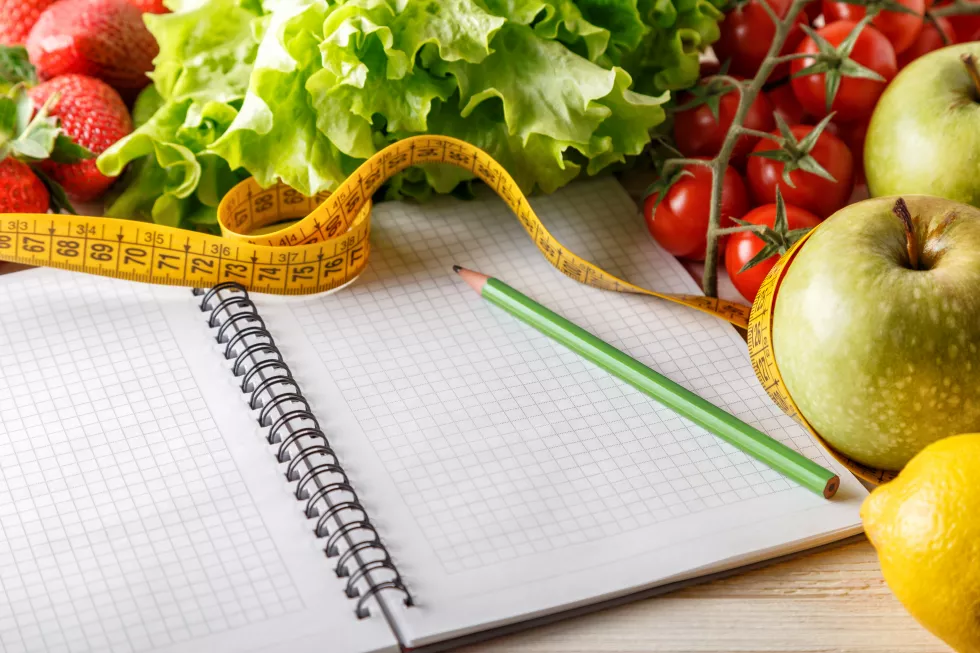 fresh-organic-vegetables-fruits-open-blank-notebook-pen