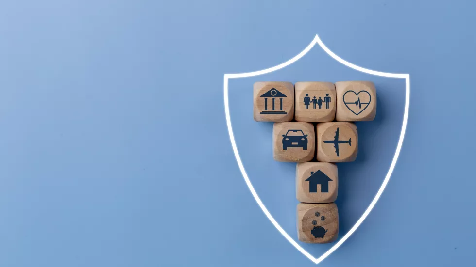 life-insurance-concept-with-wooden-blocks-icons-various-types-insurance-blue-background